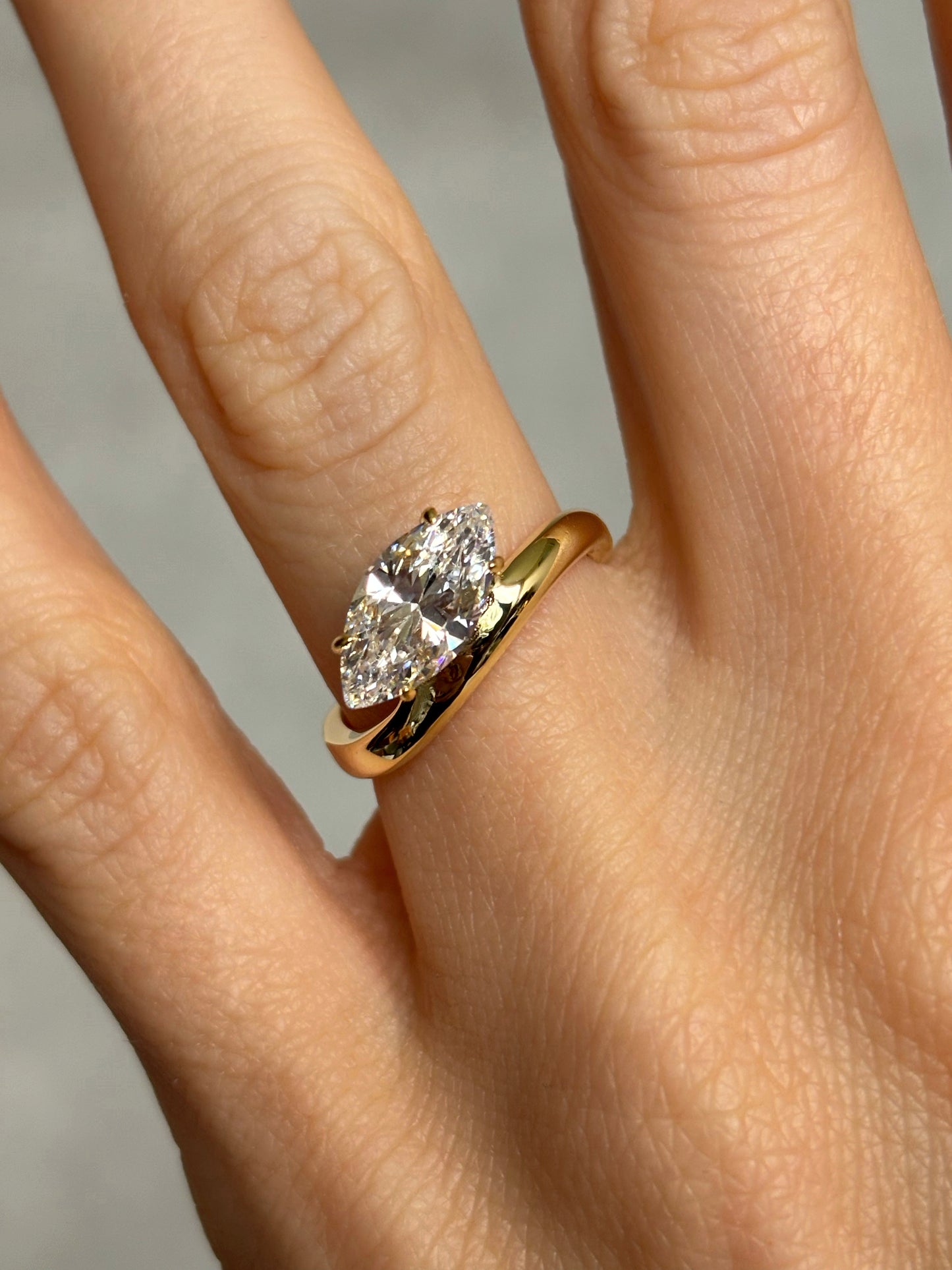 Marquise stone ring with curved band