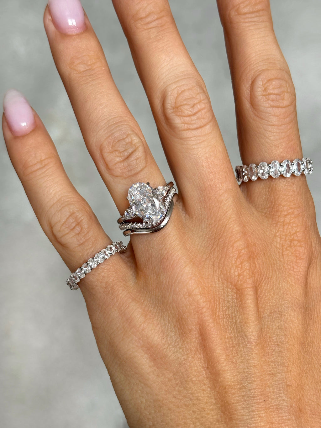 Oval stone ring with pear-cut side stones