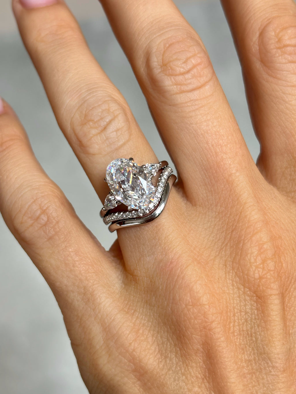 Oval stone ring with pear-cut side stones
