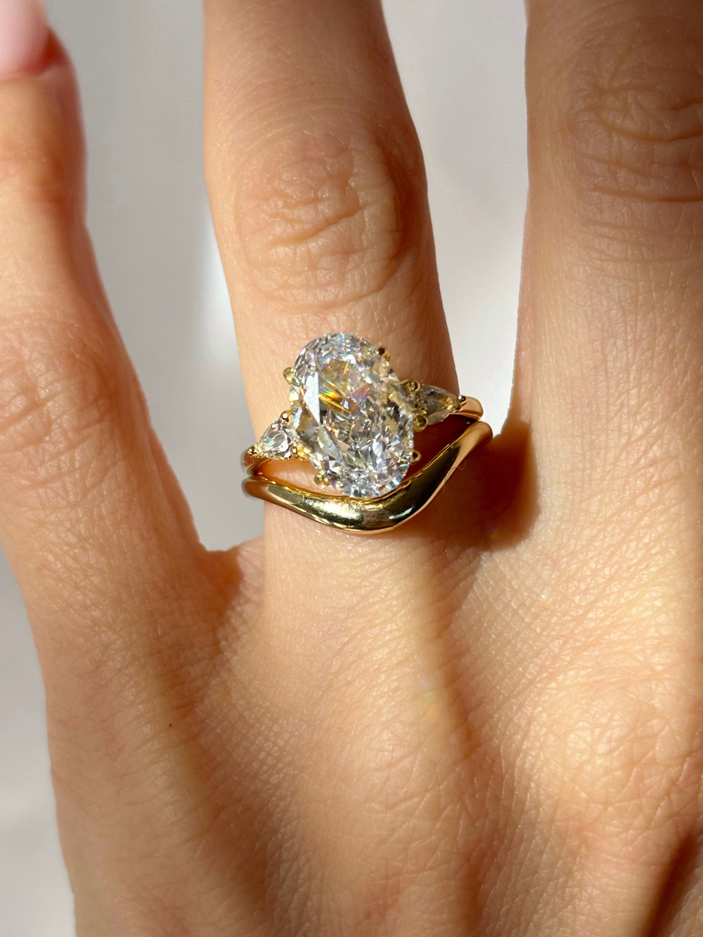 Oval stone ring with pear-cut side stones