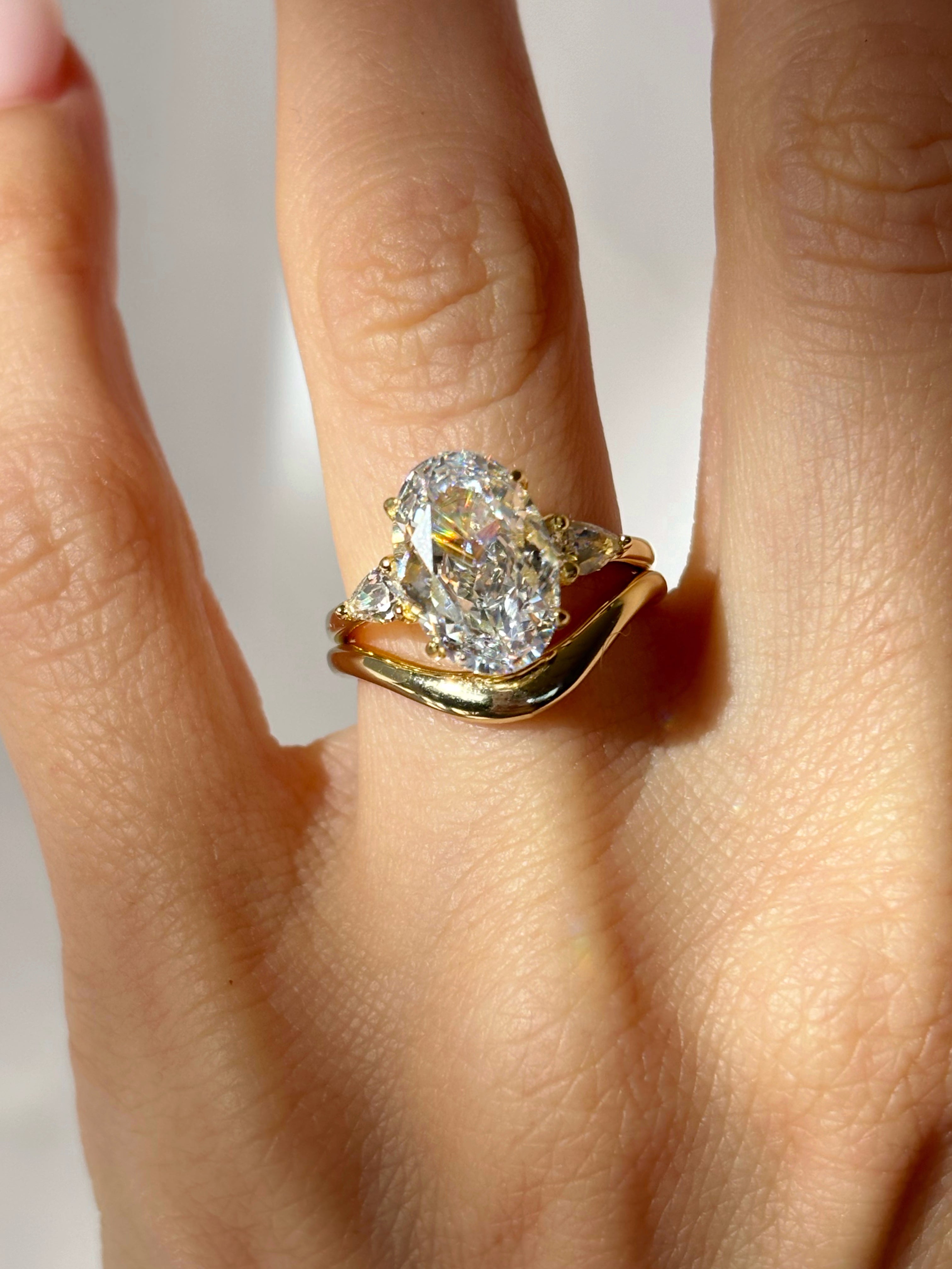 Oval stone ring with pear-cut side stones