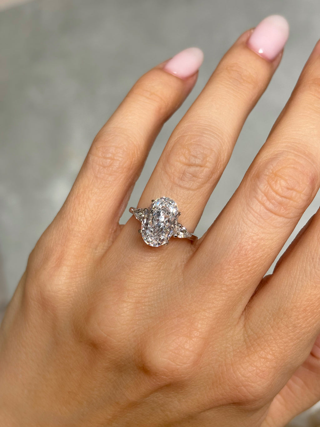 Oval stone ring with pear-cut side stones