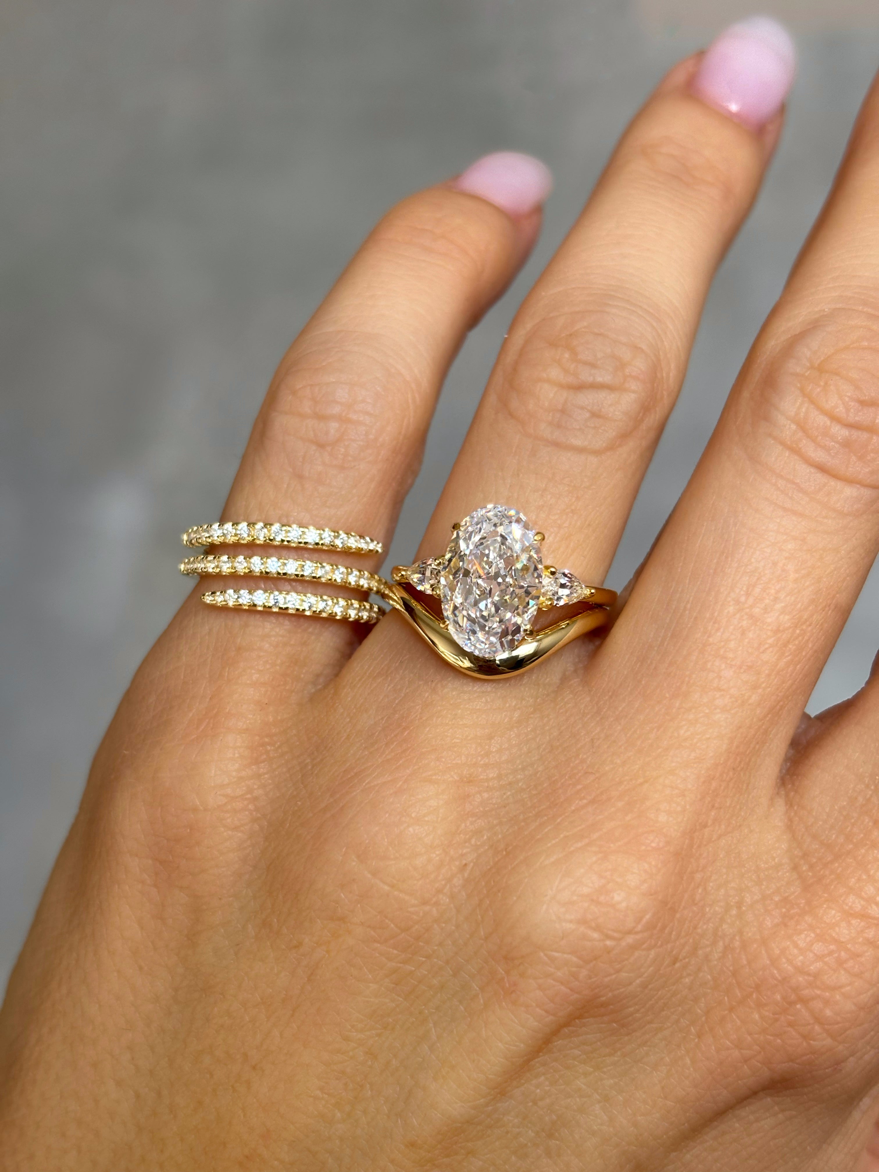 Oval stone ring with pear-cut side stones