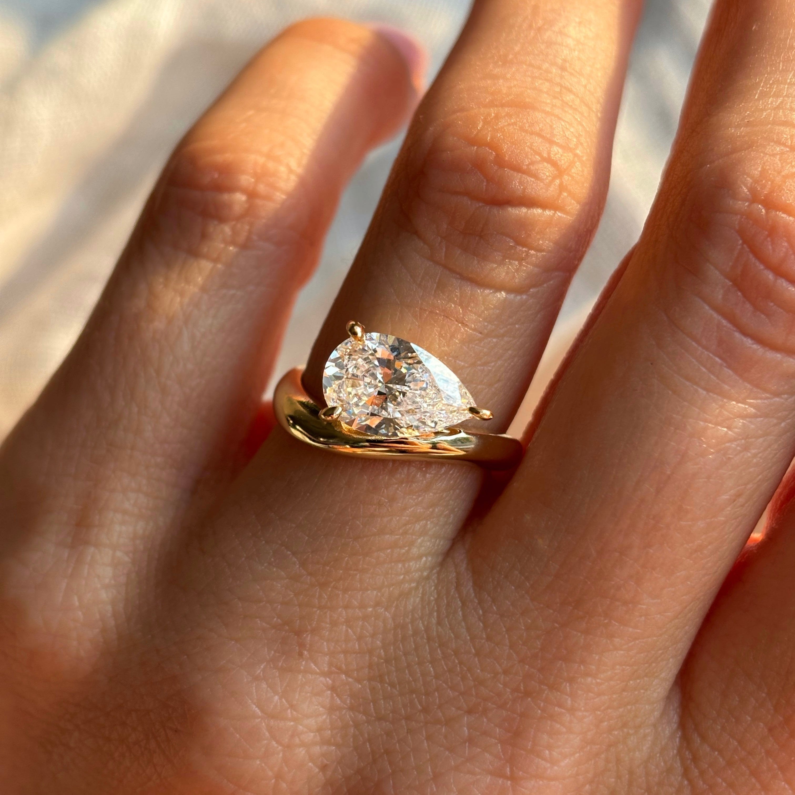 Pear stone ring with curved band